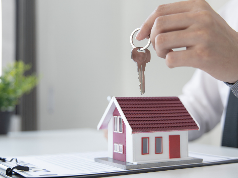  loan officer handing over house keys after mortgage closing